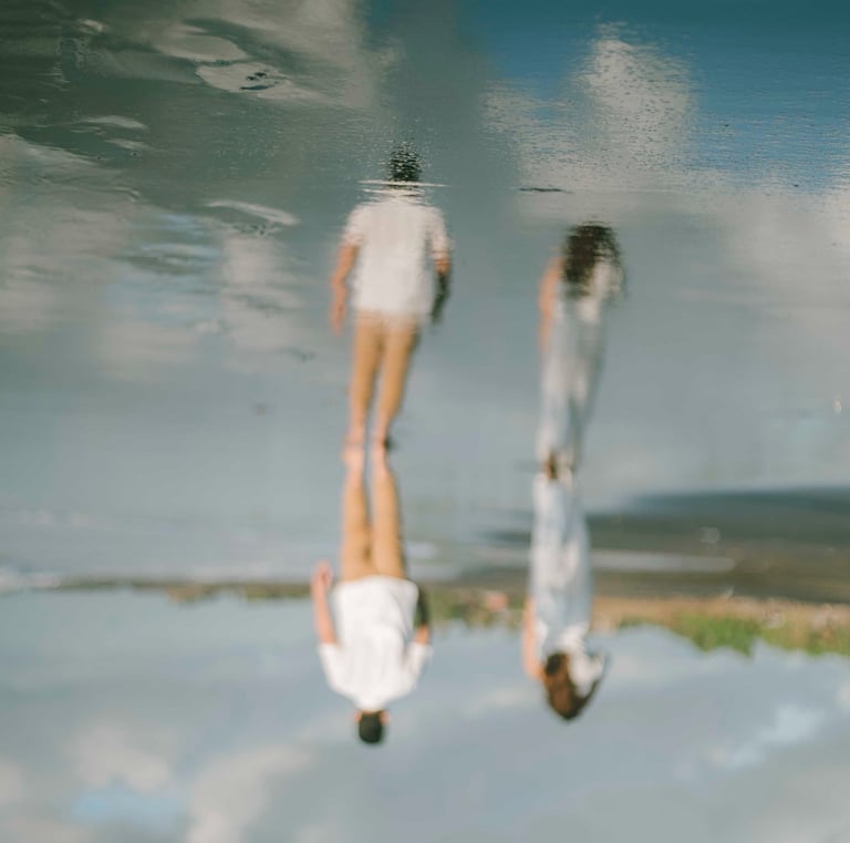 Intimate couple portrait at Pantai Nyanyi Bali with artistic reflection