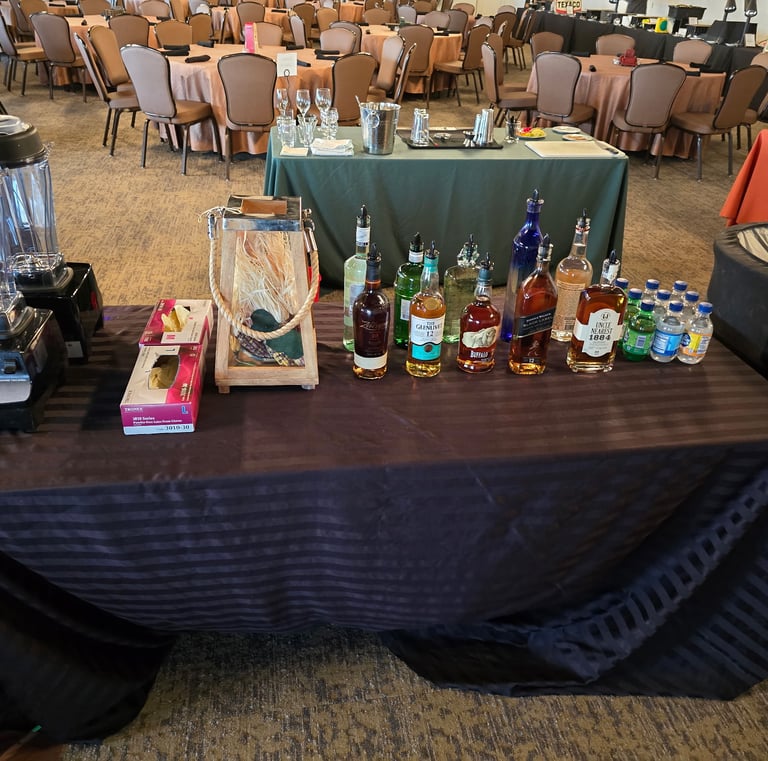 a table with a table cloth covered with bottles of alcohol