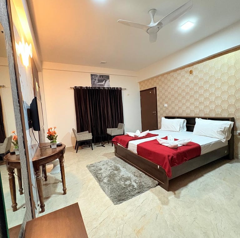 a bedroom with a bed and a television