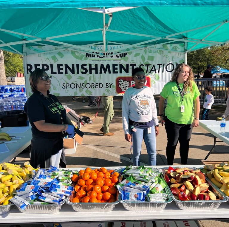 Volunteers at the fruit and replenishment station at the Tuscaloosa Mayor's Cup race