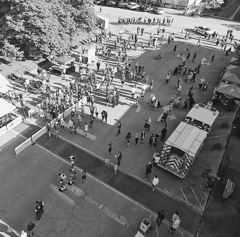 an overhead drone shot of the starting line and expo booths of the North Alabama Chick Fil A 10K