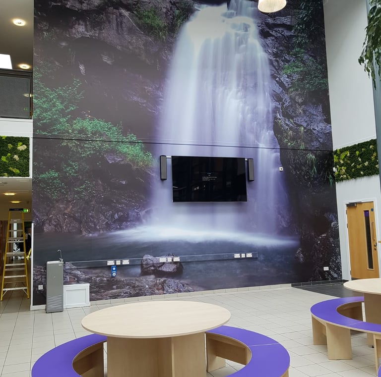 a large waterfall in a large room with a tv