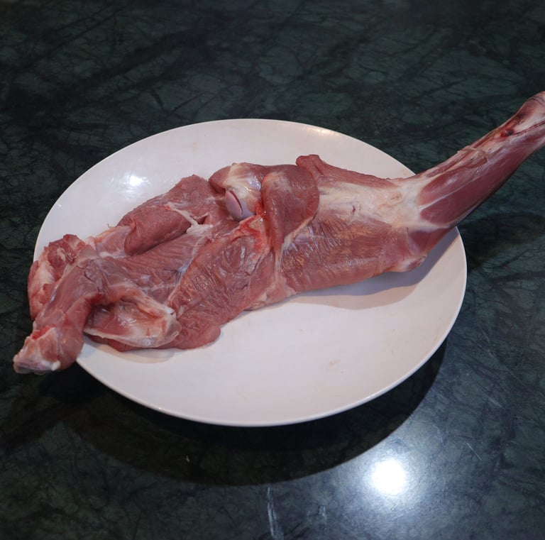 a piece of  shoulder meat on a plate with a piece of meat on it