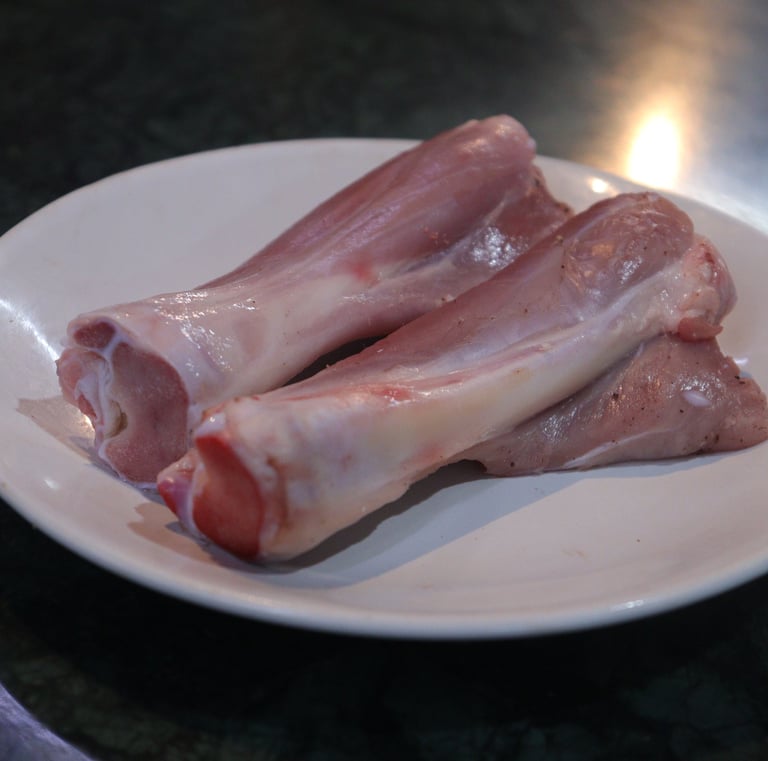 a plate of raw meat nalli piece of meat on it