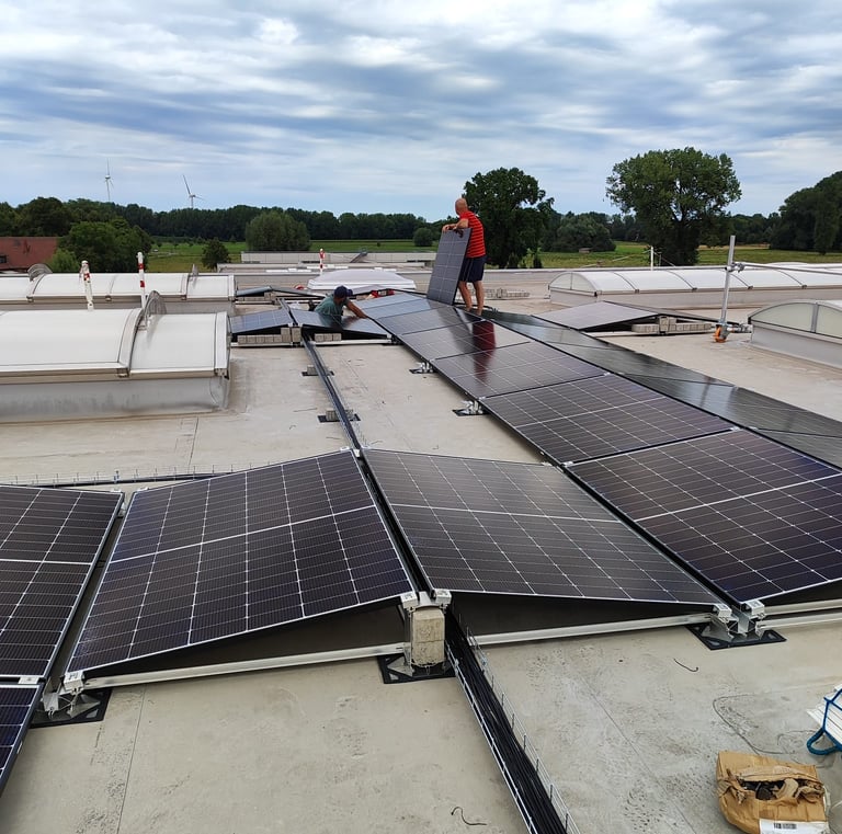 a man standing on a roof top with solar panels
