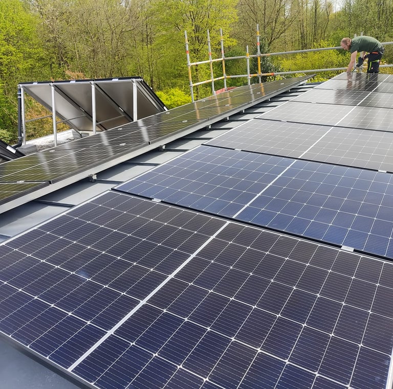 a man standing on a roof top with solar panels