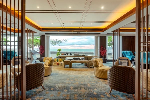 a living room with a large window and a view of the ocean