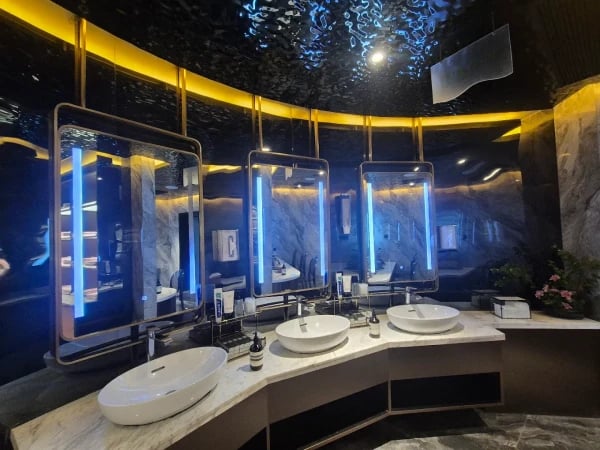 a bathroom with a large mirror and a sink