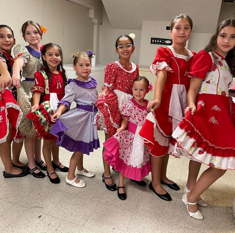 a group of young girls in dresses