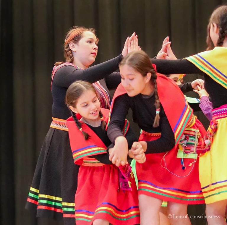 a group of young girls in colorful dresses and colorful clothes