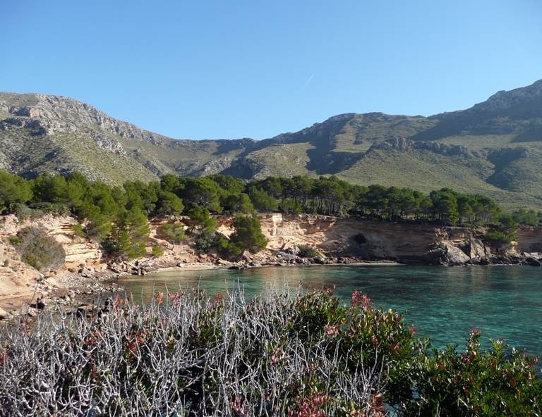 a mountain scene with a body of water and mountains in the background
