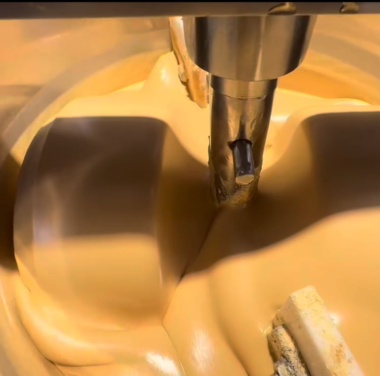 white chocolate being prepared in a chocolate grinding machine