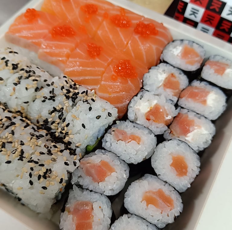 a box of sushi with salmon and avocado