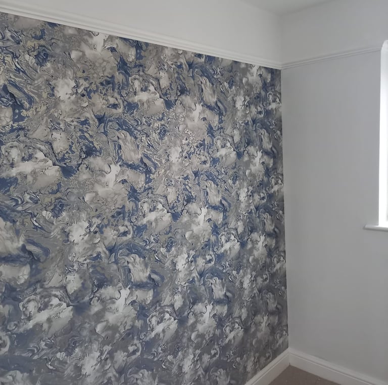 a room with a seaspray wallpapered wall