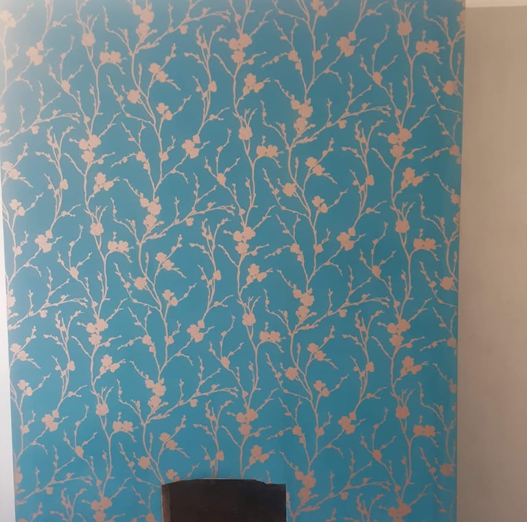 a fireplace with turquoise wallpaper