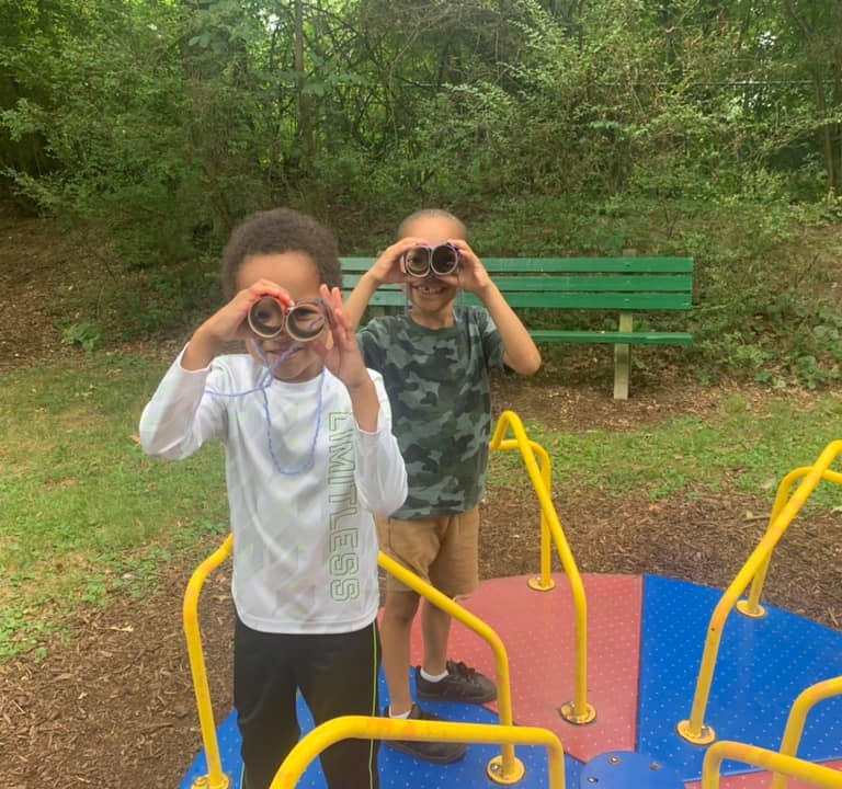 Children playing on the merry-go-round at Crescent Hills park