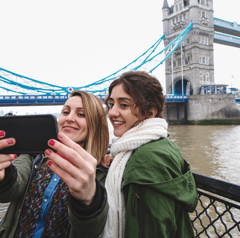 two tourist taking a selfie with a phone