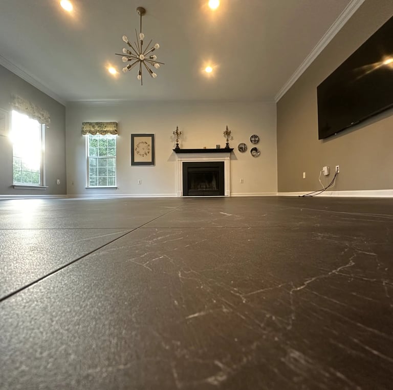a living room with a fireplace, and newly installed vinyl tile