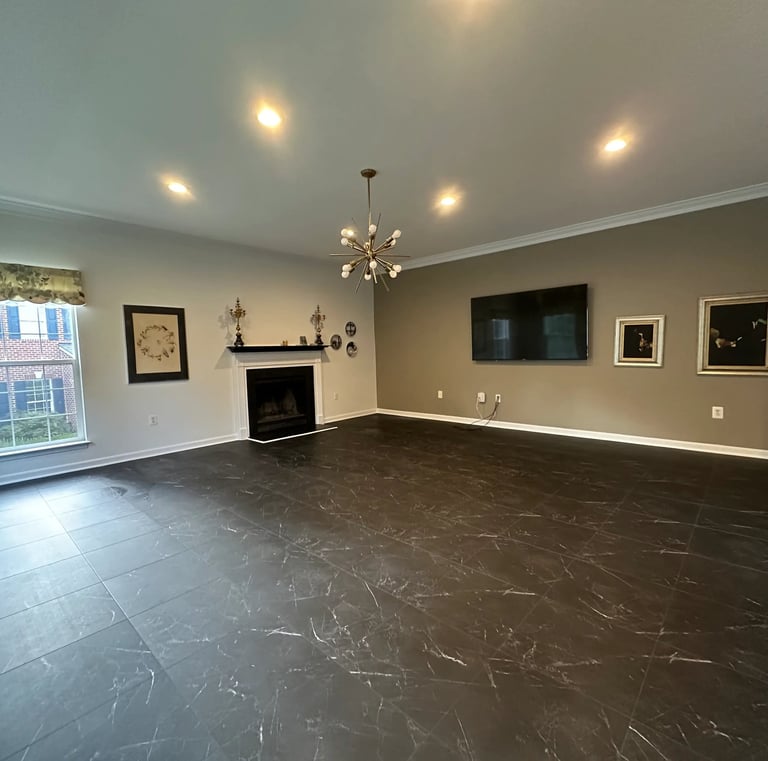 a living room with a fireplace and vinyl tile