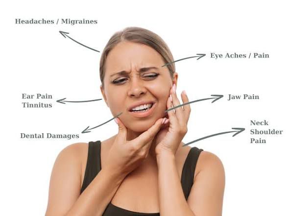 A woman experiencing TMJ symptoms including jaw pain, migraines, and ear pain