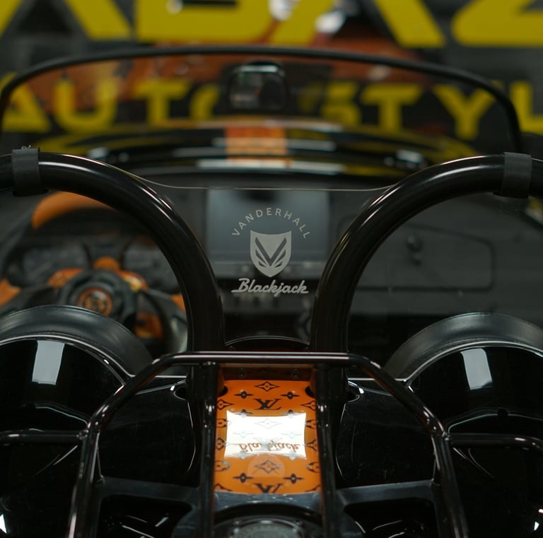 Vanderhall Blackjack autocycle interior with custom orange Louis Vuitton monogram wrap and roll bars.
