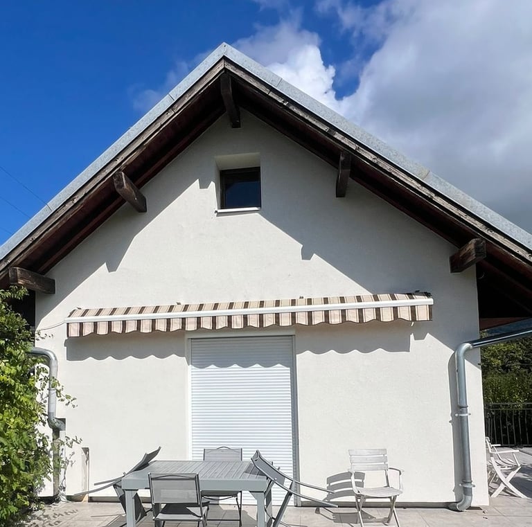 a house with a table and chairs outside