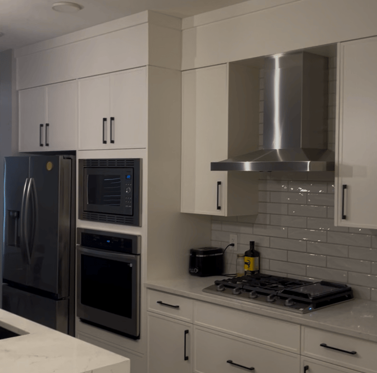 a kitchen with a large white counter top