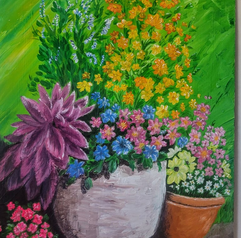 a collection of flowers in flower pots in acrylic