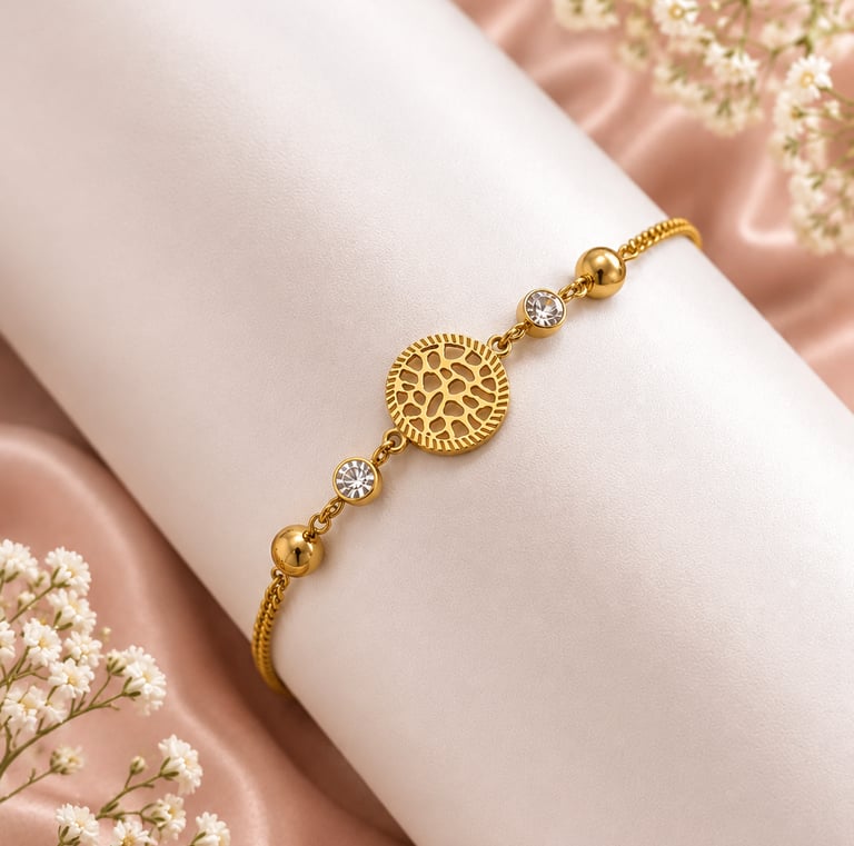 Elegant gold filigree bracelet with crystal accents displayed on a white stand with baby's breath flowers.