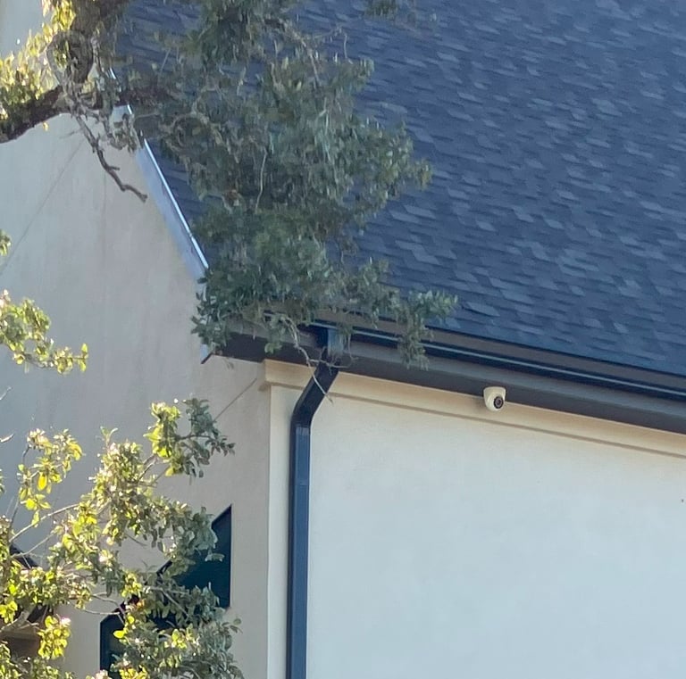 turret camera installed on eave of home