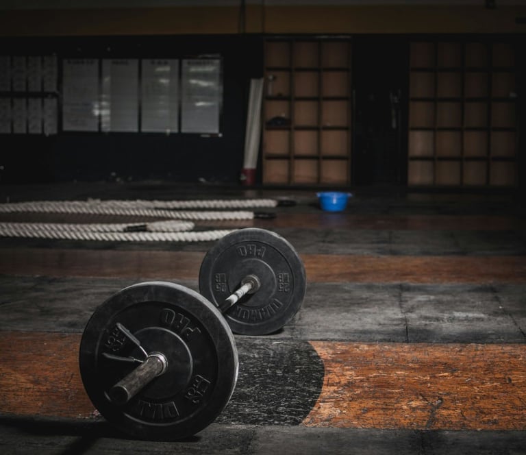 two black and white weights on a gym floor