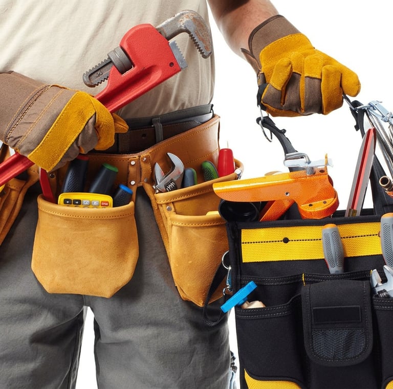 Professional plumber with full tool belt and kit ready for work