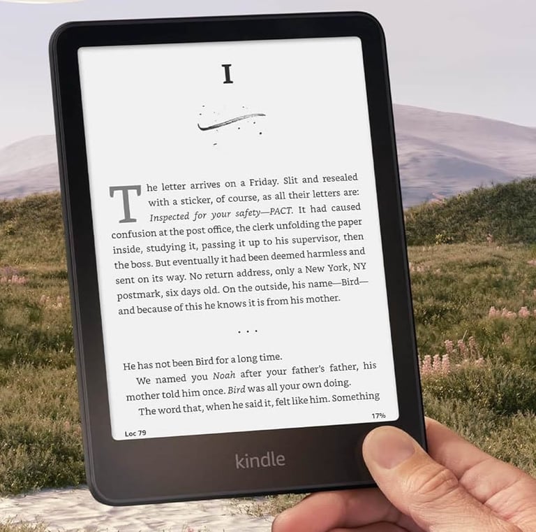 Woman enjoying a Kindle e‑reader while relaxing outdoors..