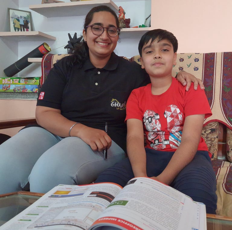 a woman and a boy sitting on a couch