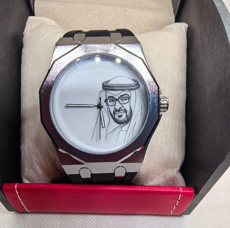 Custom silver luxury watch featuring a portrait of Sheikh Mohamed bin Zayed on a white dial.