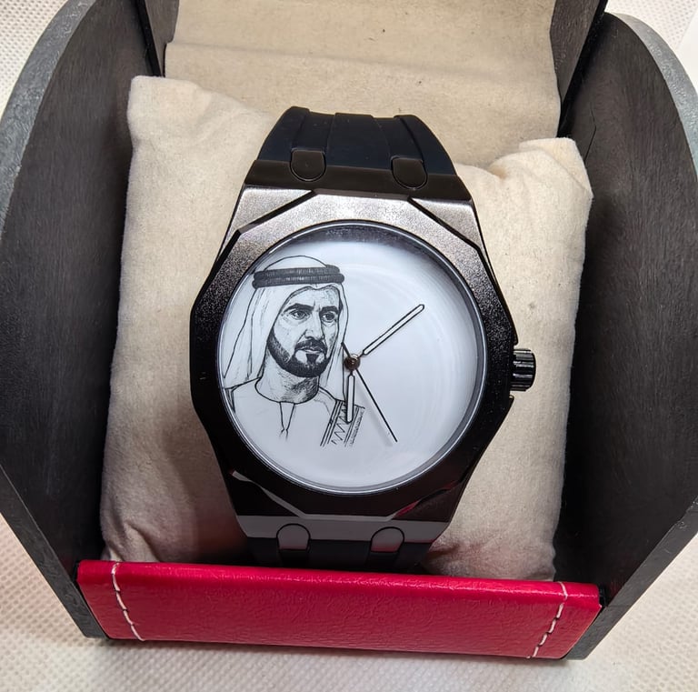 Luxury black watch with a white dial featuring a portrait of Sheikh Zayed in a presentation box.