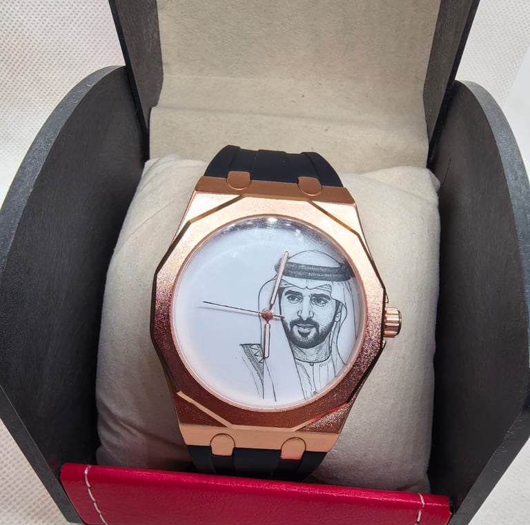 Luxury rose gold watch with a black strap featuring a portrait of an Arab leader in a black display box.