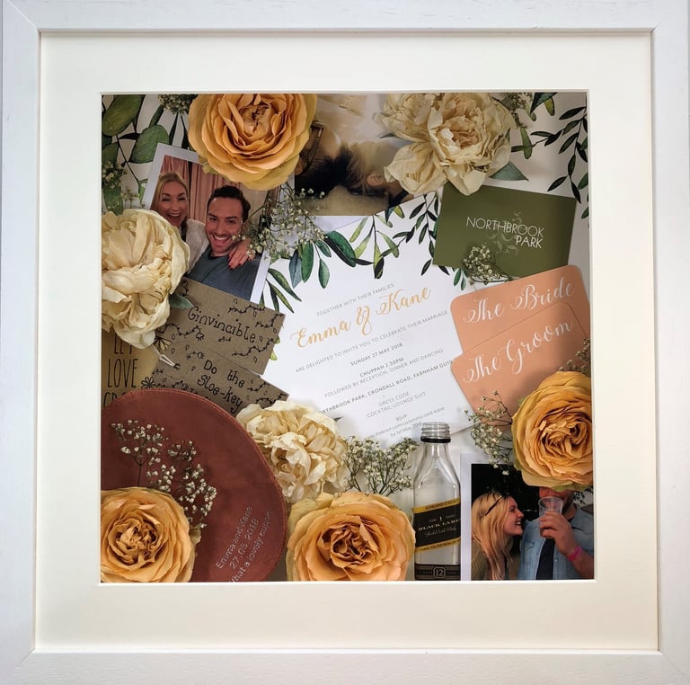 a photo of a memory box full of wedding items and preserved wedding bouquet flowers in a deep frame