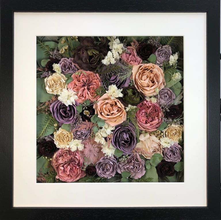 a flower wall style preserved wedding bouquet  of pinks and pinks in a frame