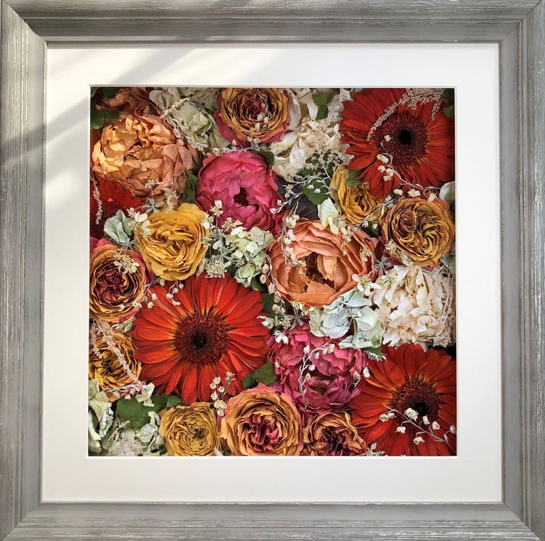 a bright  flower wall style preserved wedding bouquet in a frame