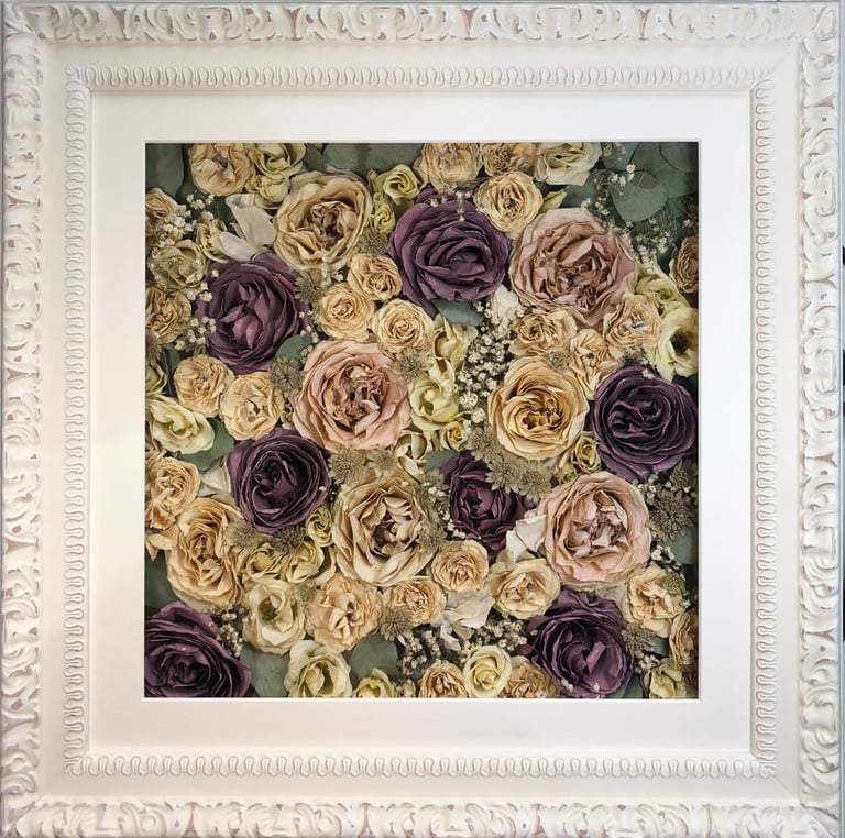 a Flower Wall Style bouquet of flowers in an ornate white frame