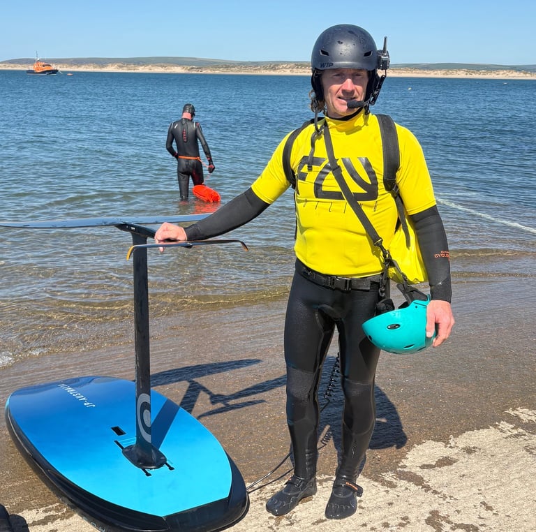 Instructor standing on the slipway with radio headset and high vis vest