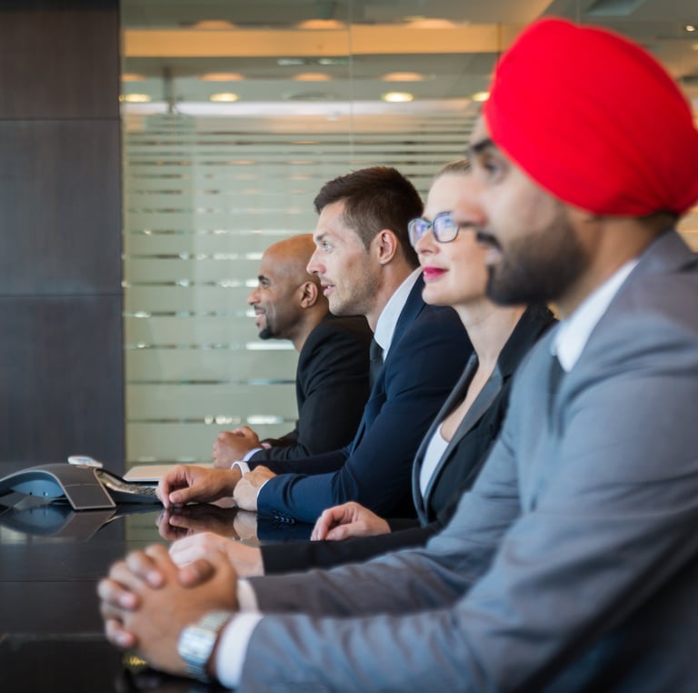 a group of business people sitting at a table