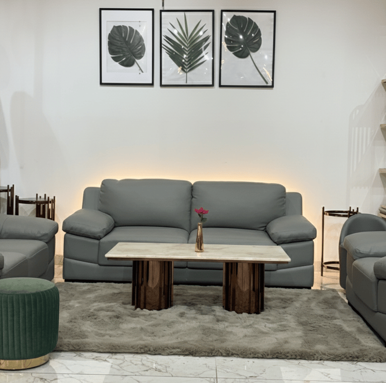 Modern grey sofa set with center table at furniture showroom in Bengaluru