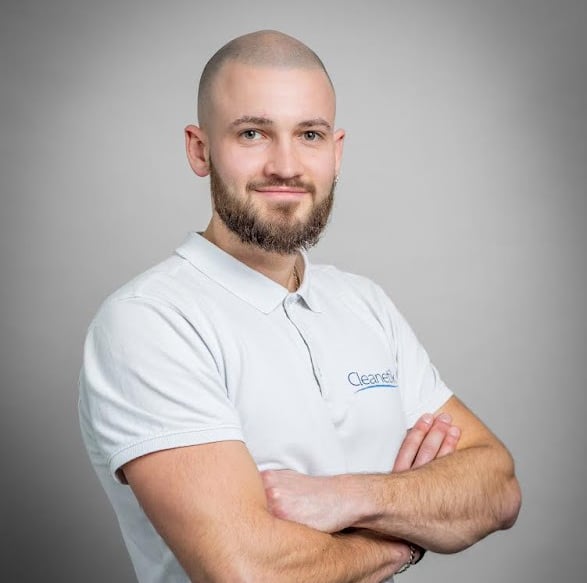 a man with a bald haircut and bearding