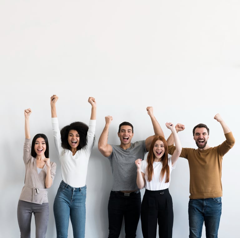 a group of people standing in front of a white wall