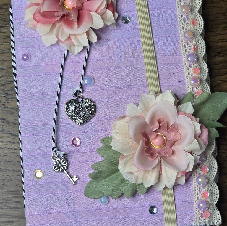 Purple fabric covered journal, handmade fabric flowers, bakers twine, crystal and silver charms