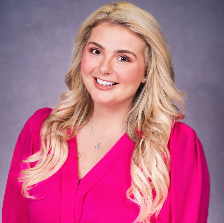 Ashley-Shae Benton, founder of Snackable Studio, smiling in pink top professional headshot