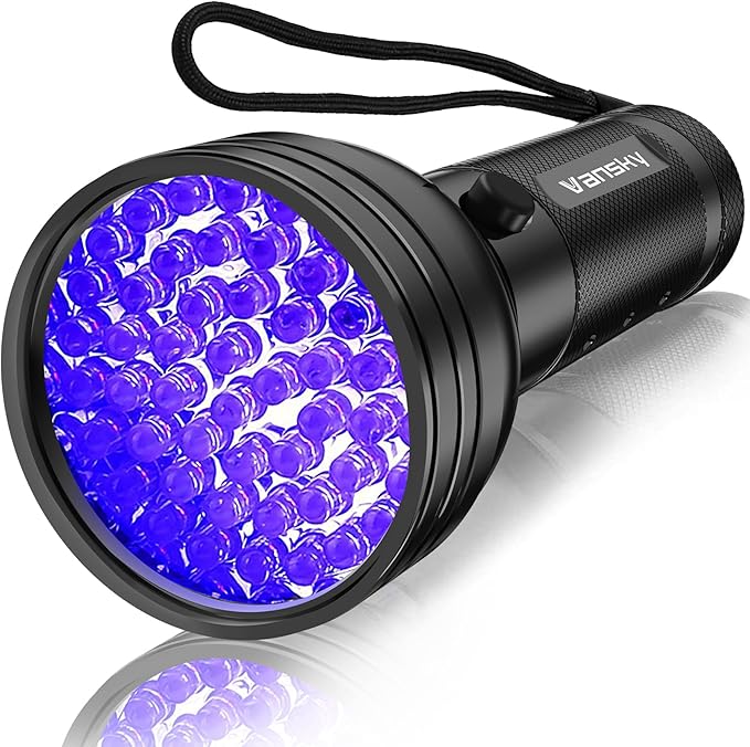 UV blacklight flashlight detecting hidden pet stains on carpet
