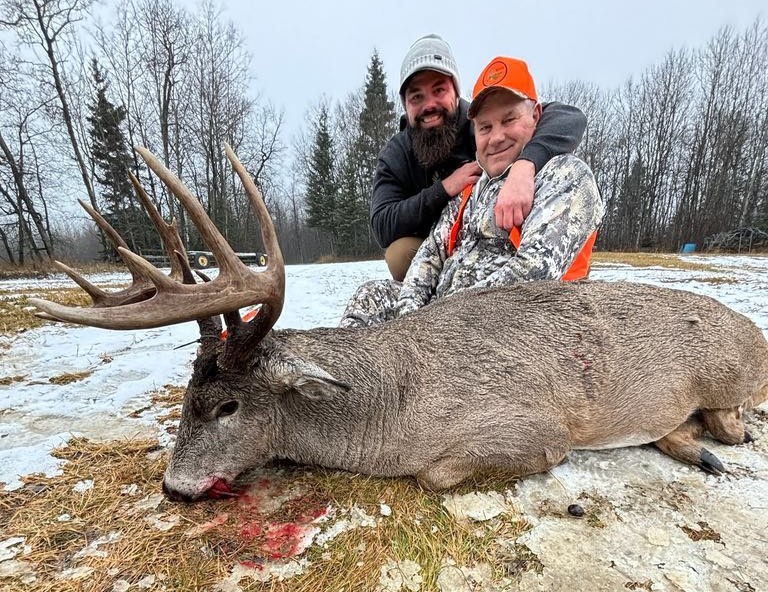 Saskatchewan whitetail hunts - father and son with big saskatchewan whitetail